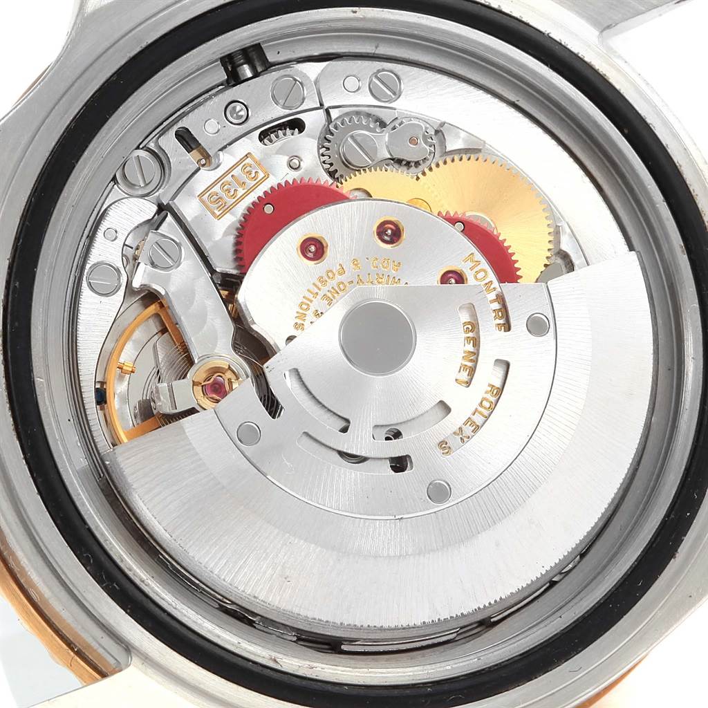 This image shows the internal movement mechanism of the Rolex Submariner 16613 Men's Steel and Gold (two tone) Blue Dial 16613 Men's Steel and Gold (two tone) Blue Dial watch, including gears and the rotor.