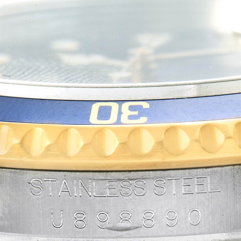 The image shows a close-up of the bezel and case, featuring the "STAINLESS STEEL" engraving, on a Rolex Submariner 16613 Men's Steel and Gold (two tone) Blue Dial 16613 Men's Steel and Gold (two tone) Blue Dial watch.