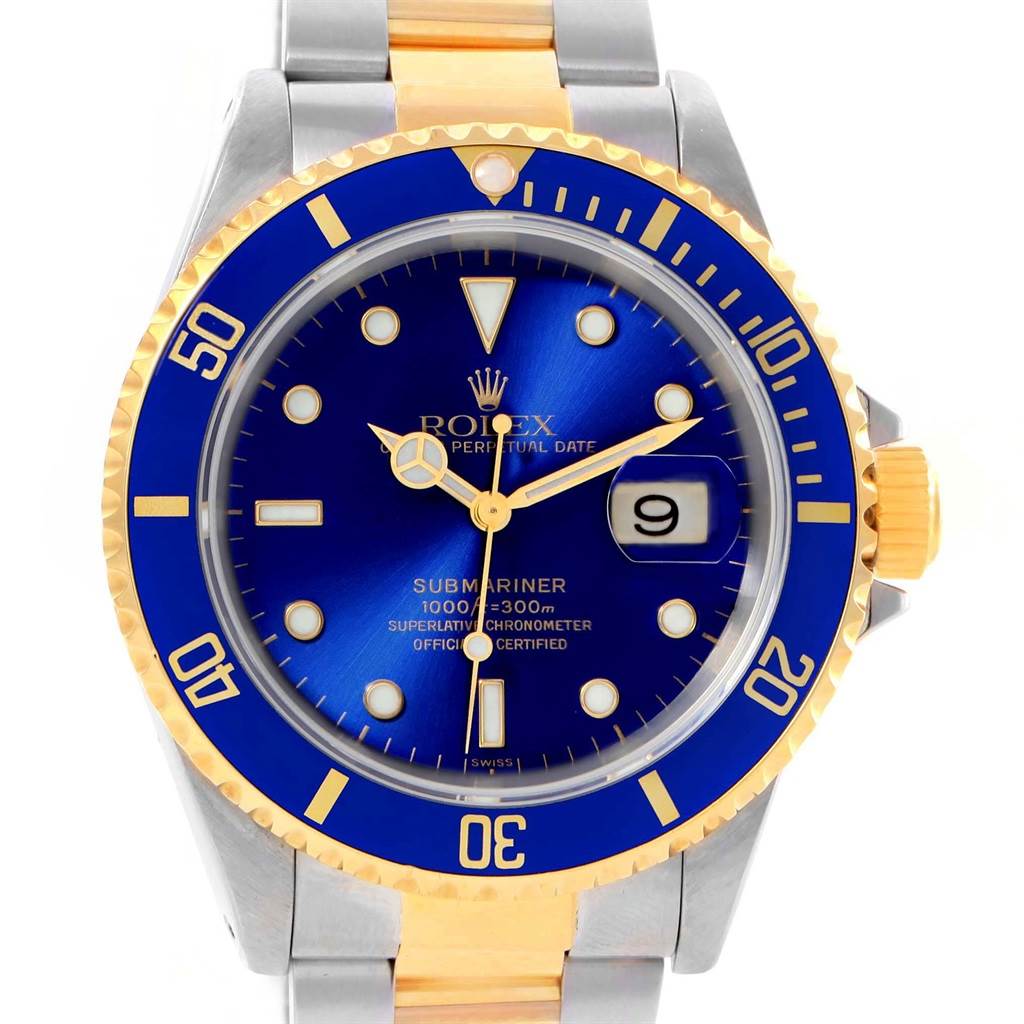 This image shows a close-up view of a Rolex Submariner 16613 Men's Steel and Gold (two tone) Blue Dial 16613 Men's Steel and Gold (two tone) Blue Dial watch featuring a blue dial, gold and silver bracelet, and a date window.