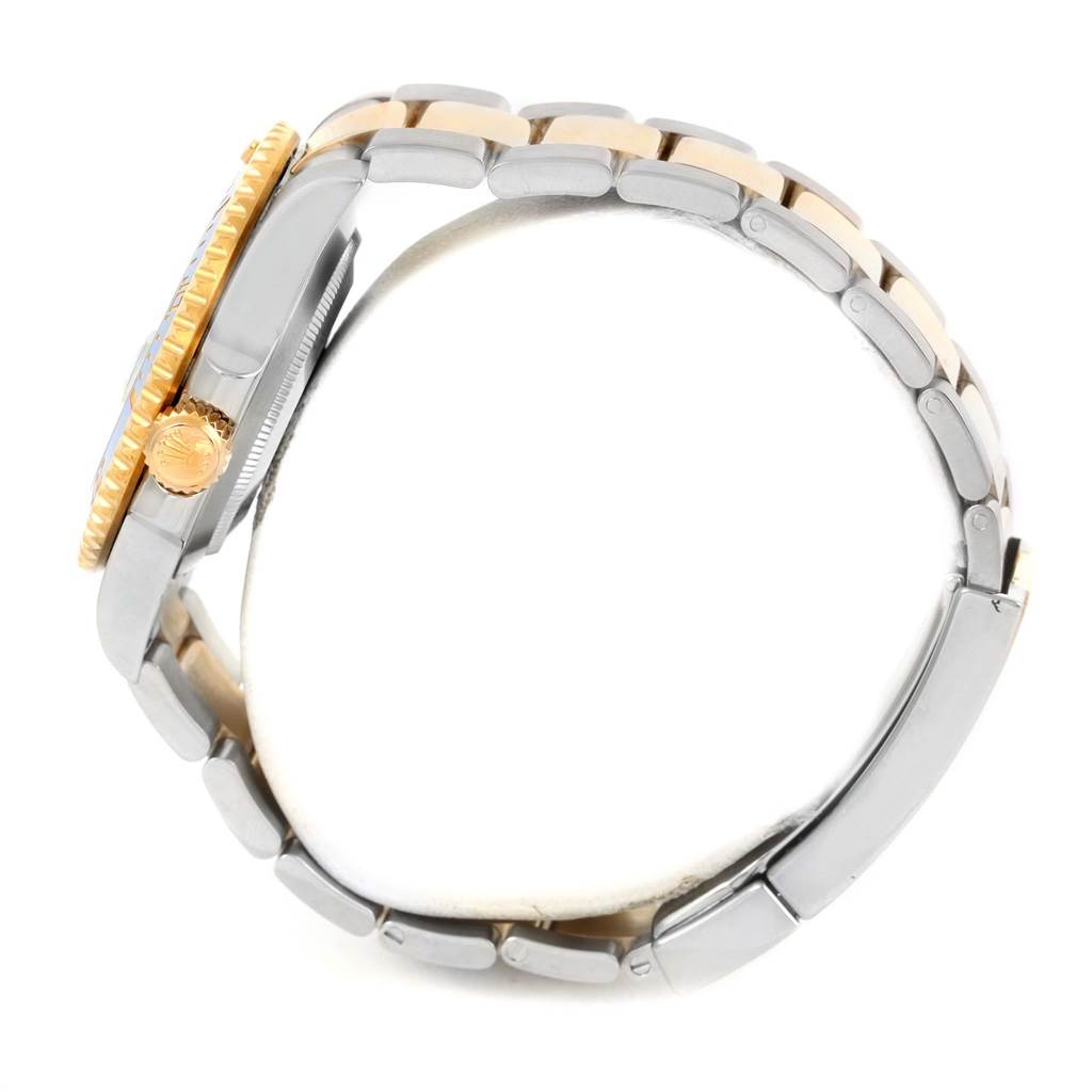 The image shows a side view of a Rolex Submariner 116613 Men's Steel and Gold (two tone) Blue Dial 116613 Men's Steel and Gold (two tone) Blue Dial watch, highlighting its crown, bezel, and two-tone bracelet.