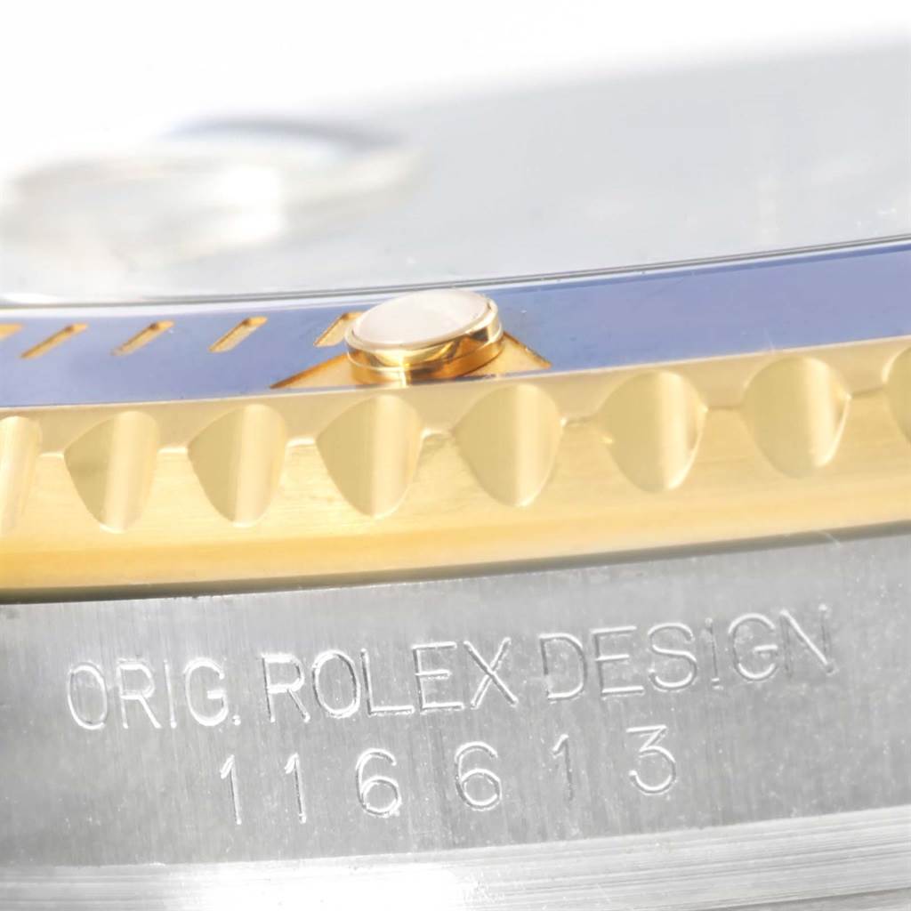 This close-up image showcases the bezel and case with the model number of a Rolex Submariner 116613 Men's Steel and Gold (two tone) Blue Dial 116613 Men's Steel and Gold (two tone) Blue Dial 116613.