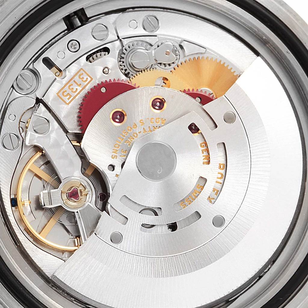 The image shows a close-up of the movement mechanism of a Rolex Submariner 16610 Men
s Stainless Steel Black Dial 16610 Men
s Stainless Steel Black Dial watch, highlighting gears and components.