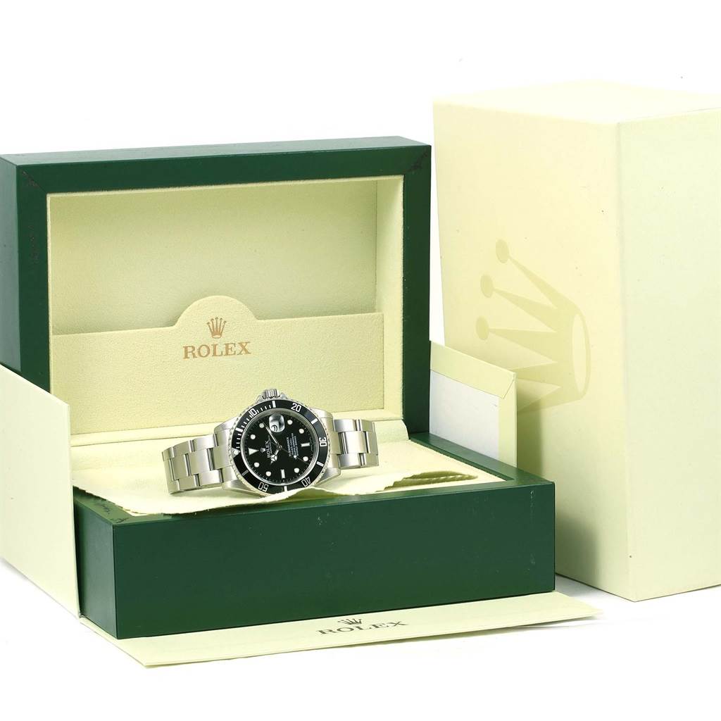 This image shows a Rolex Submariner 16610 Men
s Stainless Steel Black Dial 16610 Men
s Stainless Steel Black Dial watch inside its open box, displaying the dial, bezel, and bracelet.
