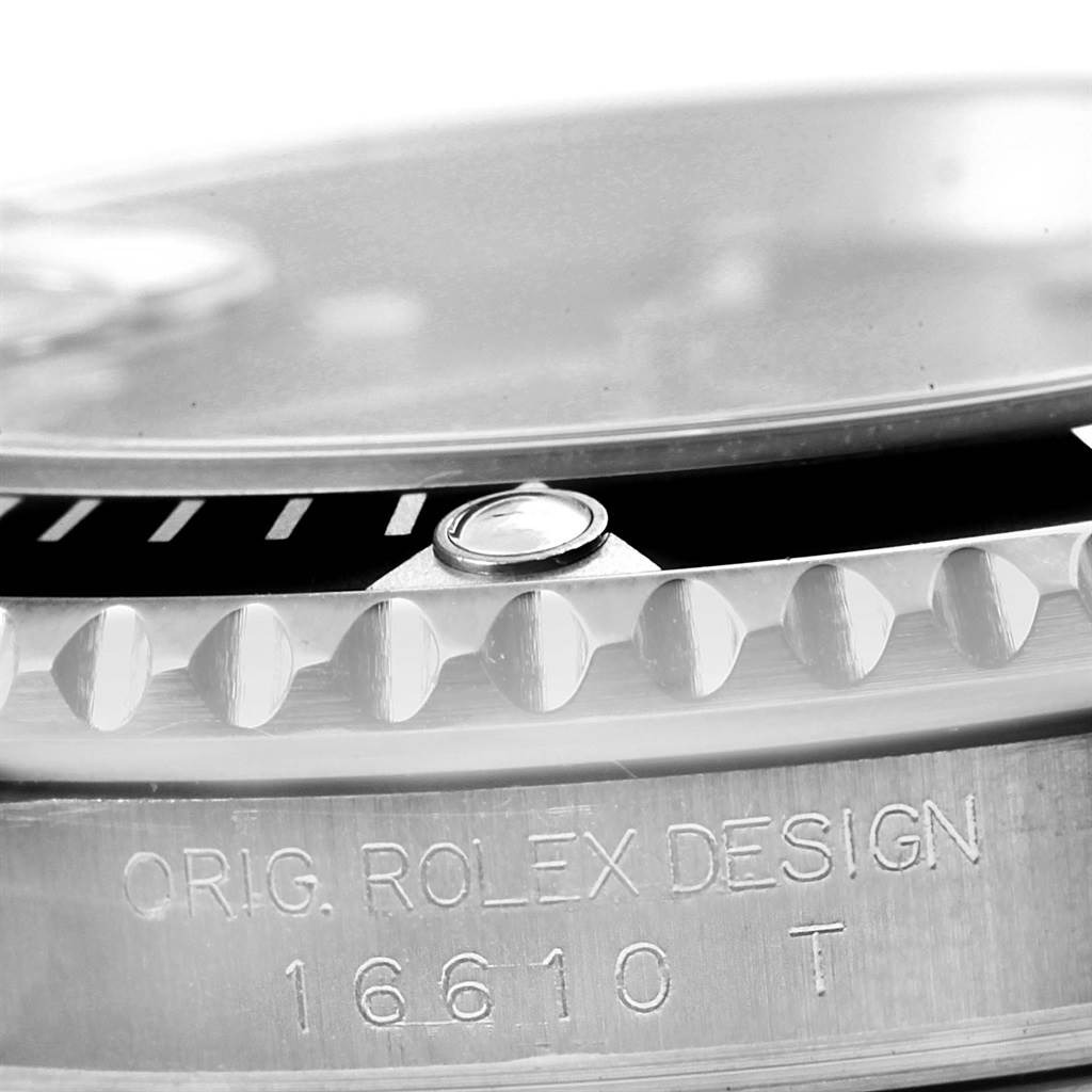This close-up image shows the bezel, the serial number, and part of the glass of a Rolex Submariner 16610 Men
s Stainless Steel Black Dial 16610 Men
s Stainless Steel Black Dial 16610.