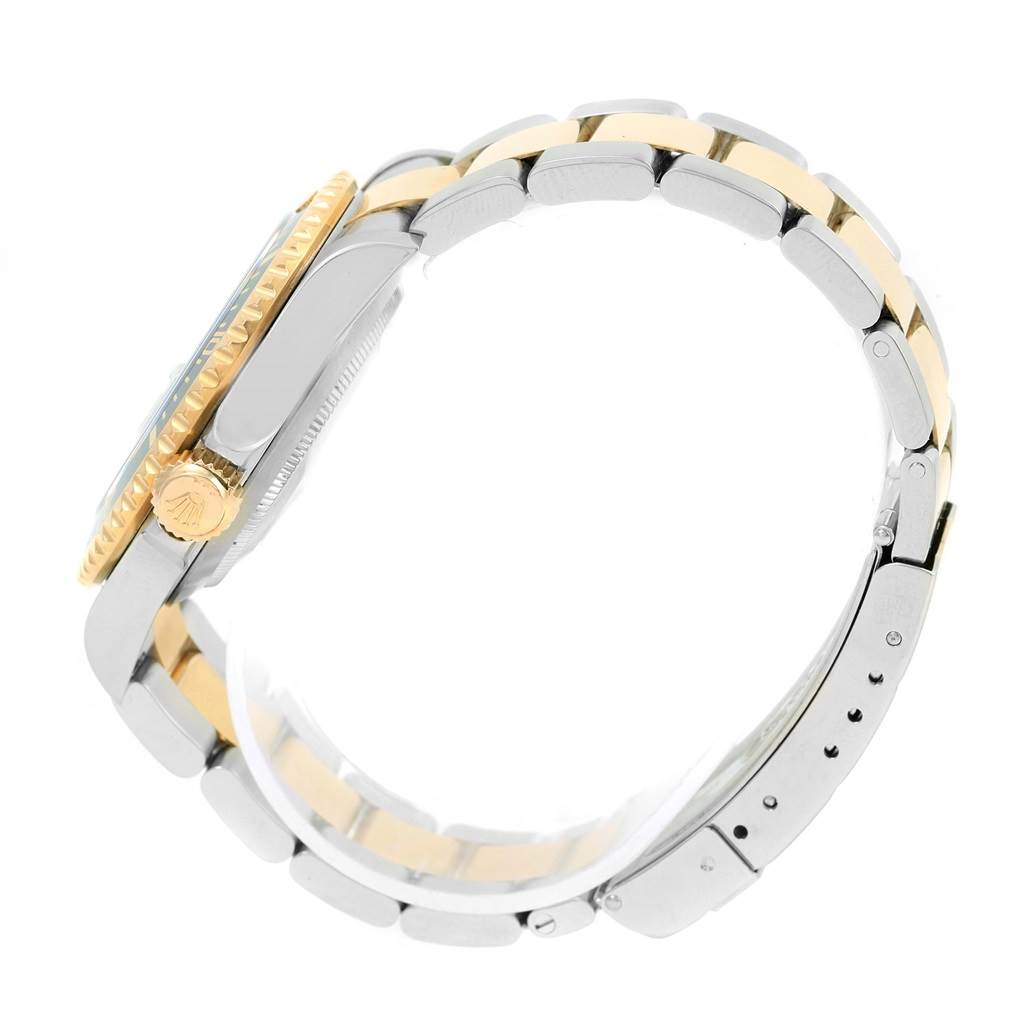 This image shows a side view of the Rolex Submariner 16613 Men
s Steel and Gold (two tone) Black Dial 16613 Men
s Steel and Gold (two tone) Black Dial watch focusing on the bezel, crown, and two-tone strap.