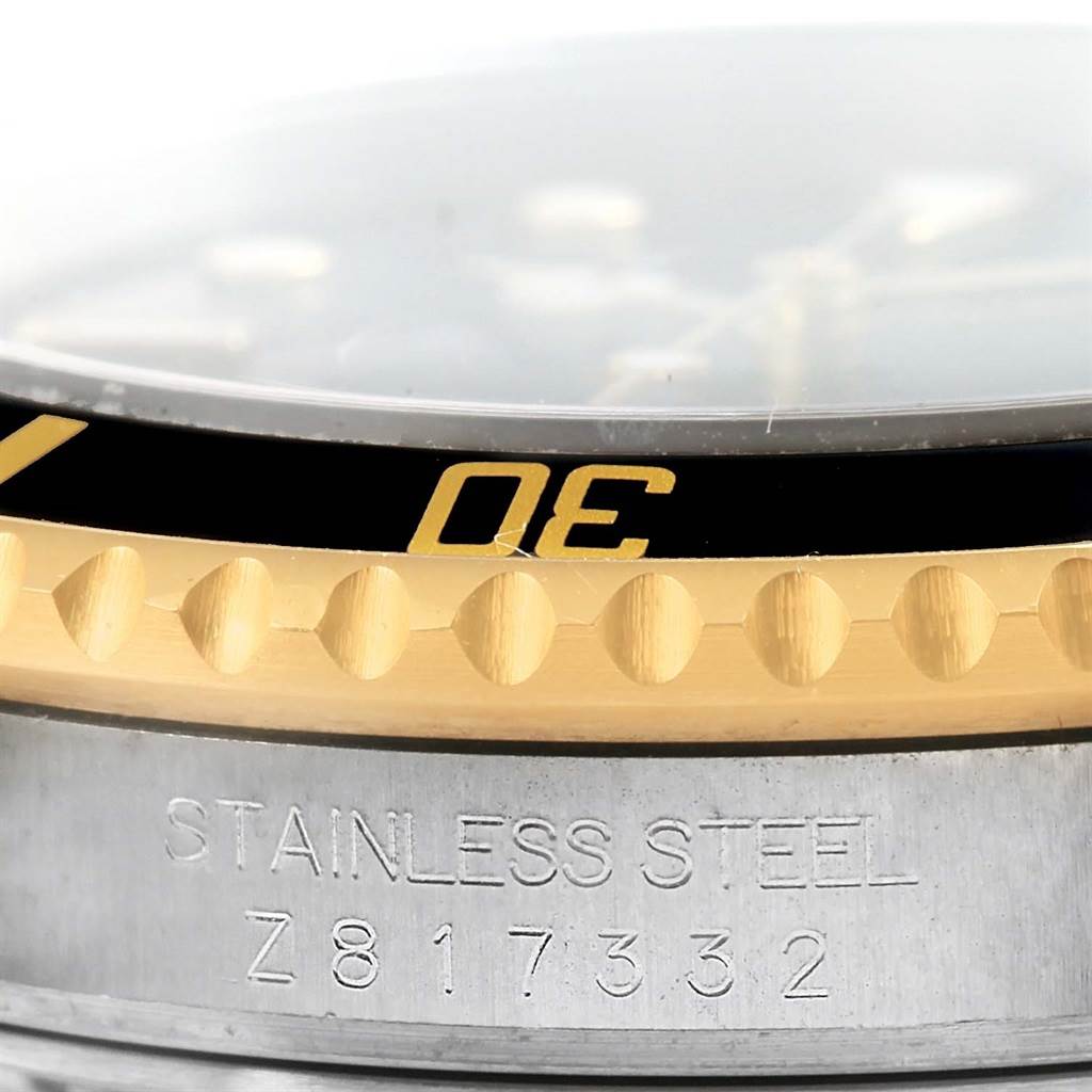 Close-up of the side and bezel of a Rolex Submariner 16613 Men
s Steel and Gold (two tone) Black Dial 16613 Men
s Steel and Gold (two tone) Black Dial watch, showing the stainless steel and serial number.