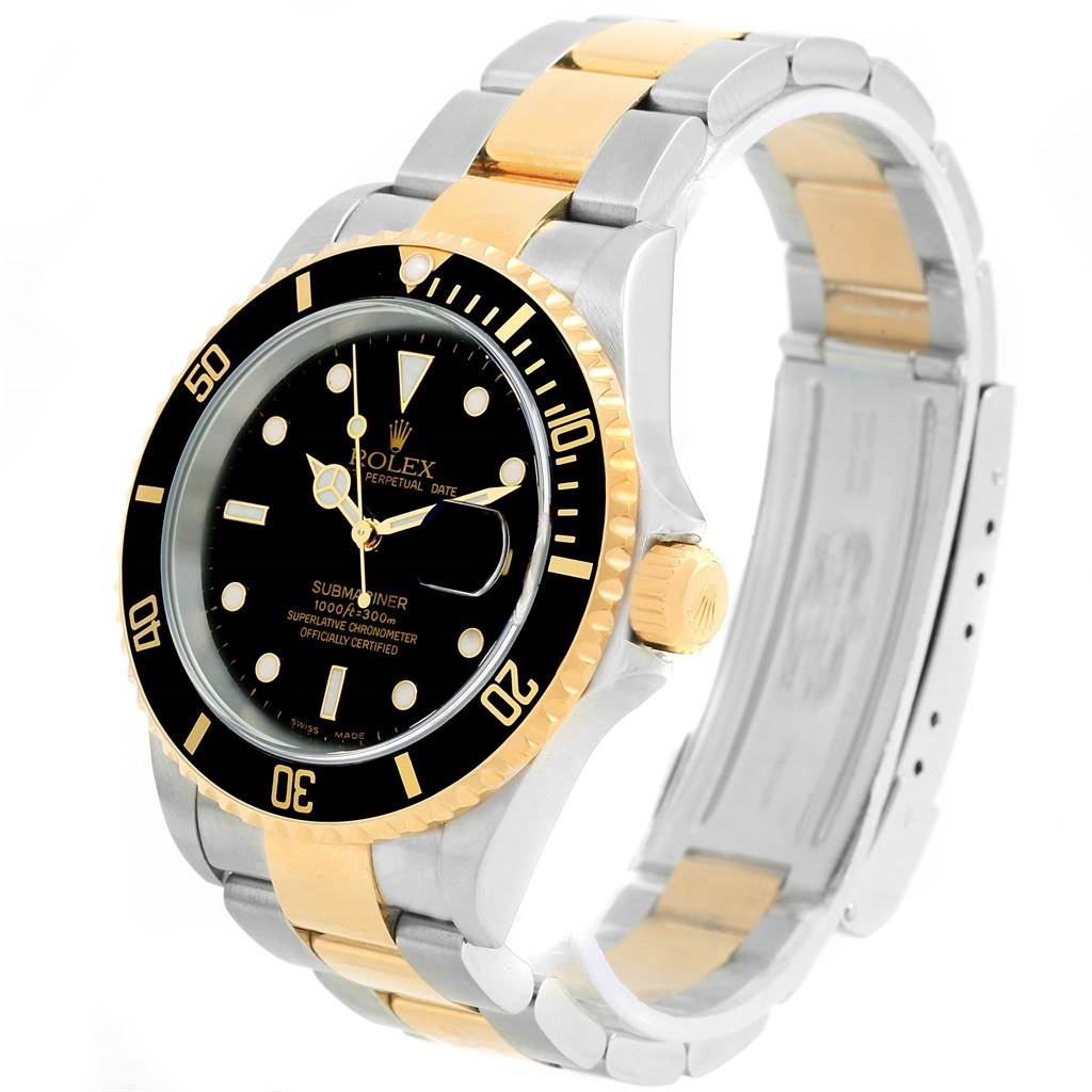 The image shows a Rolex Submariner 16613 Men
s Steel and Gold (two tone) Black Dial 16613 Men
s Steel and Gold (two tone) Black Dial watch from an angled view highlighting its black dial, bezel, and two-tone bracelet.