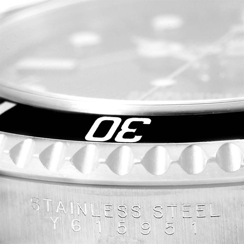 The image shows a close-up of the bezel and case of a Rolex Submariner 14060 Men
s Stainless Steel Black Dial 14060 Men
s Stainless Steel Black Dial watch, displaying the "30" marking on the bezel and "STAINLESS STEEL" on the case.