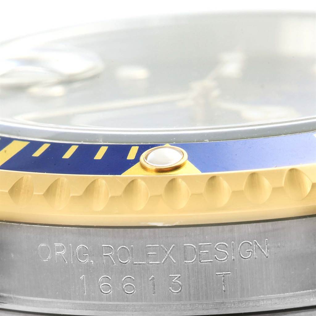 The image shows a close-up angle of the bezel and side of the case for the Rolex Submariner 16613 Men
s Steel and Gold (two tone) Blue Dial 16613 Men
s Steel and Gold (two tone) Blue Dial model 16613.