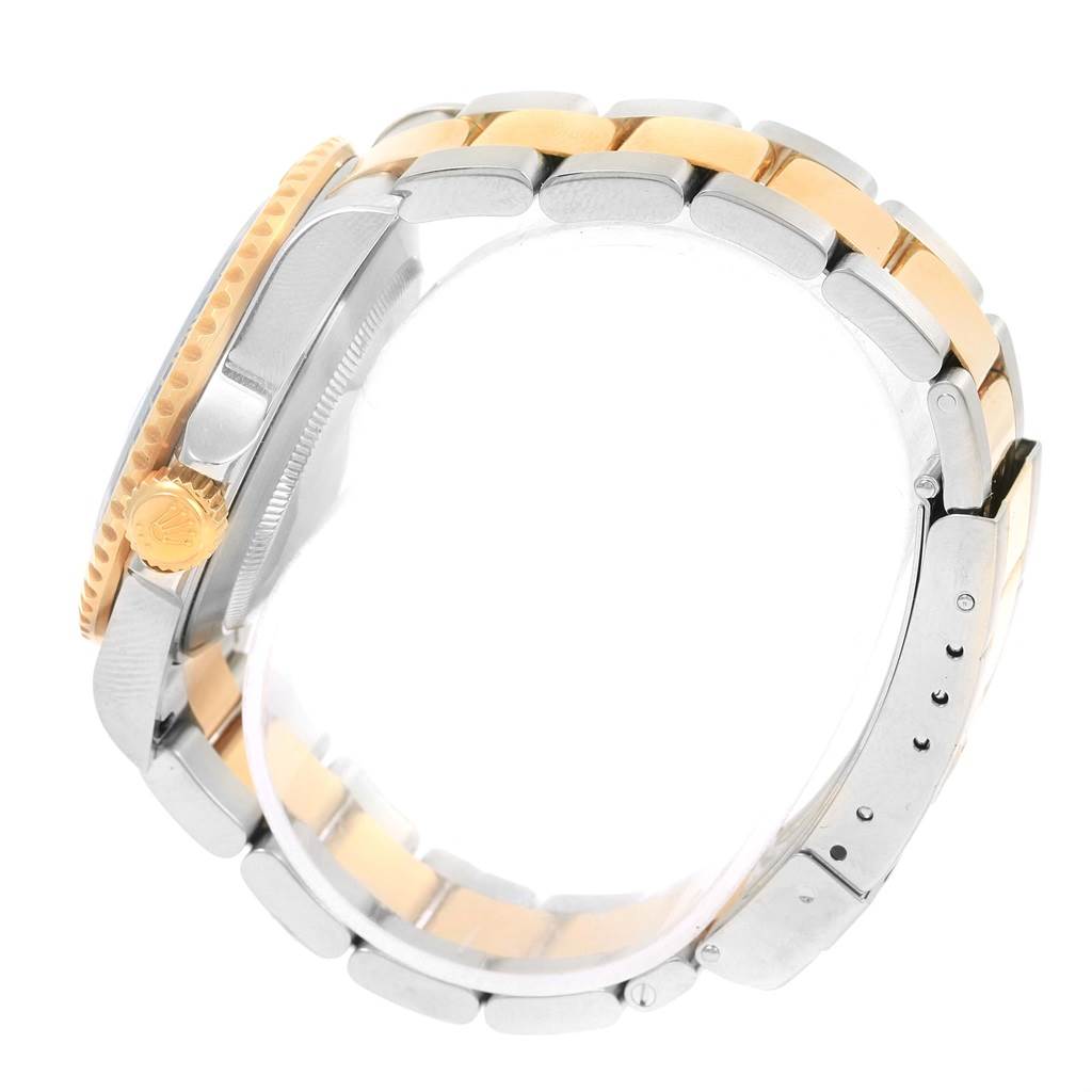 The image shows a side view of a Rolex Submariner 16613 Men
s Steel and Gold (two tone) Blue Dial 16613 Men
s Steel and Gold (two tone) Blue Dial watch, highlighting the crown, bezel, and two-tone bracelet.
