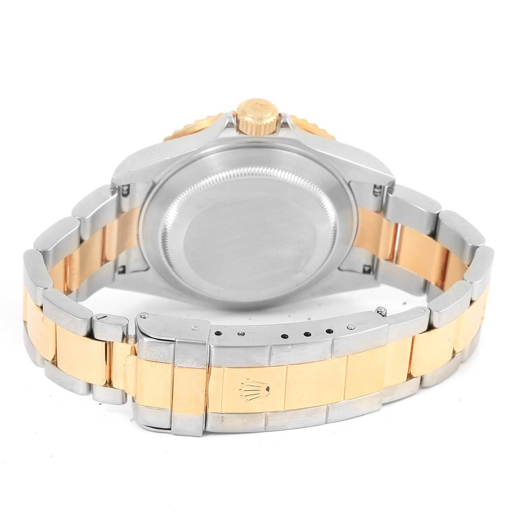 The image shows the back and bracelet of a Rolex Submariner 16613 Men
s Steel and Gold (two tone) Blue Dial 16613 Men
s Steel and Gold (two tone) Blue Dial watch, highlighting its two-tone metal design and clasp.