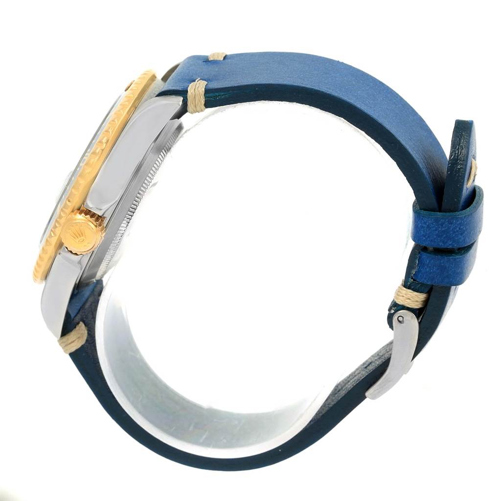The image shows a side view of a Rolex Submariner 16613 Men
s Steel and Gold (two tone) Blue Dial 16613 Men
s Steel and Gold (two tone) Blue Dial watch, highlighting its case, crown, and a blue leather strap.