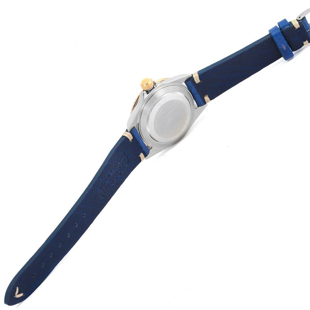 This image shows the back side of a Rolex Submariner 16613 Men
s Steel and Gold (two tone) Blue Dial 16613 Men
s Steel and Gold (two tone) Blue Dial watch with a blue leather strap.