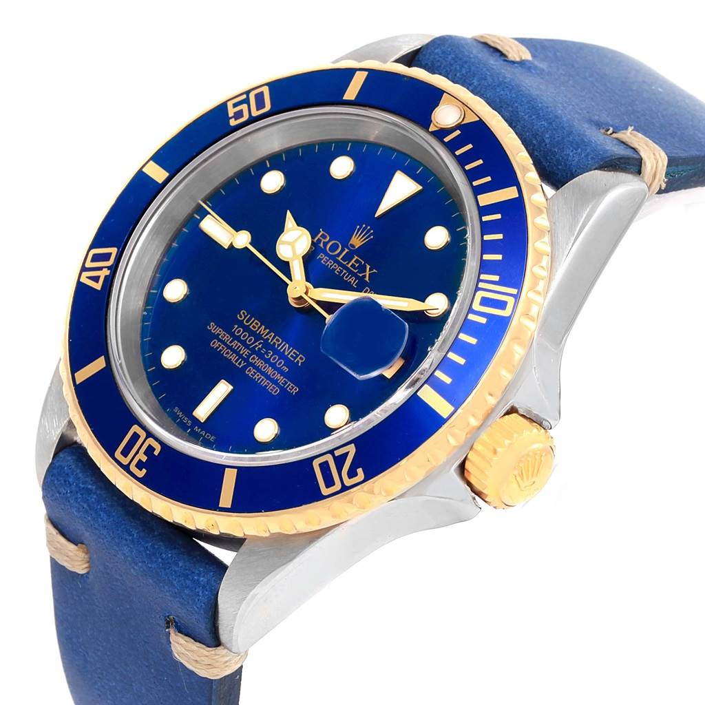 The image shows a Rolex Submariner 16613 Men
s Steel and Gold (two tone) Blue Dial 16613 Men
s Steel and Gold (two tone) Blue Dial watch angled to display its blue dial, gold bezel, case, and blue strap.