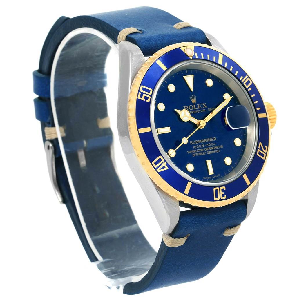 This image shows a side angle of a Rolex Submariner 16613 Men
s Steel and Gold (two tone) Blue Dial 16613 Men
s Steel and Gold (two tone) Blue Dial watch, featuring its blue dial and bezel, gold accents, and a blue strap.