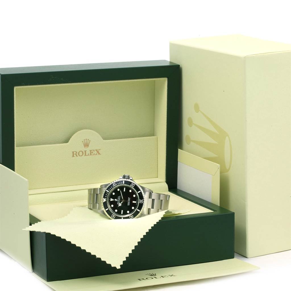 The Rolex Submariner 14060 Men's Stainless Steel Black Dial 14060 Men's Stainless Steel Black Dial watch is shown in its open box with both the face and the bracelet visible.