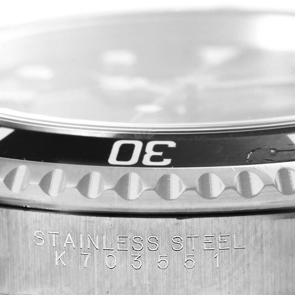 This image shows a close-up of the bezel and side of the casing with an engraved serial number on a Rolex Submariner 14060 Men's Stainless Steel Black Dial 14060 Men's Stainless Steel Black Dial watch.