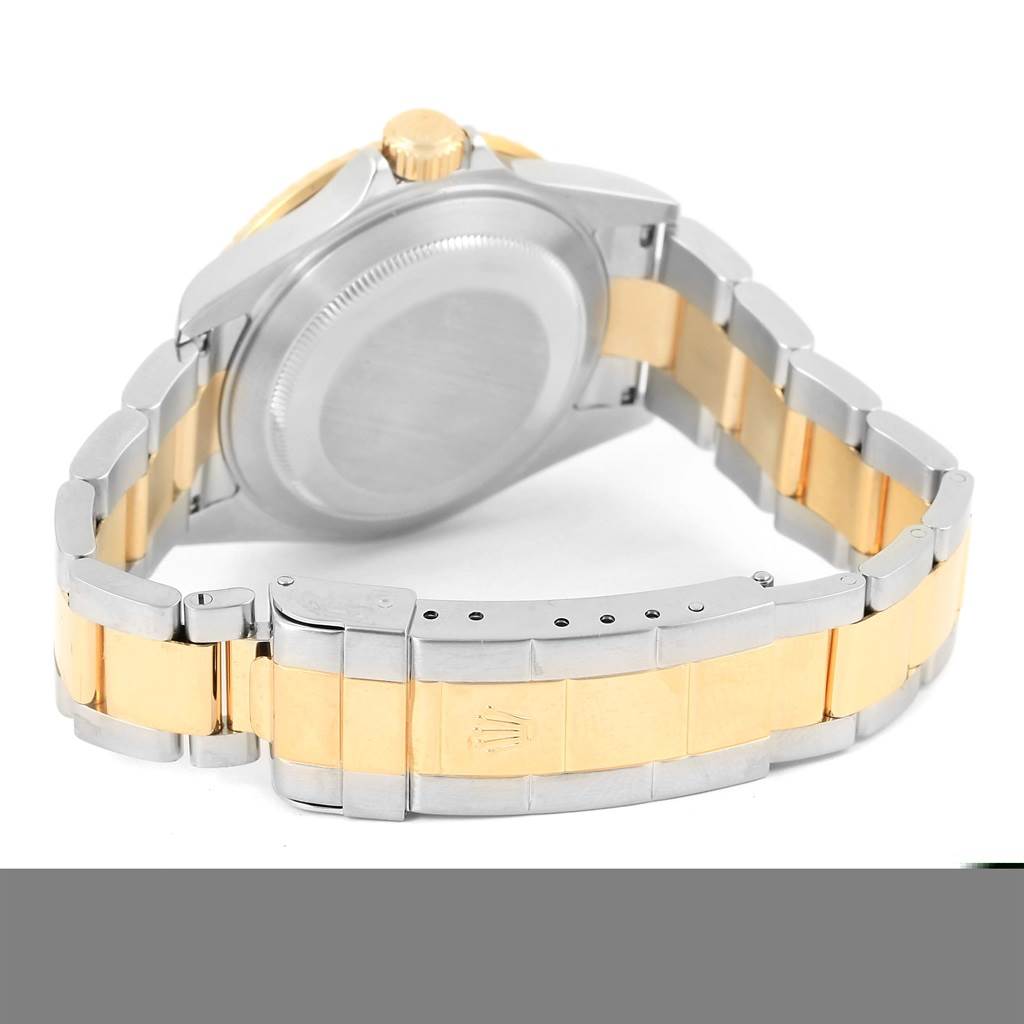 The image shows the backside and clasp of a Rolex Submariner 16613 Men
s Steel and Gold (two tone) Blue Dial 16613 Men
s Steel and Gold (two tone) Blue Dial watch, highlighting the two-tone metal bracelet and case.