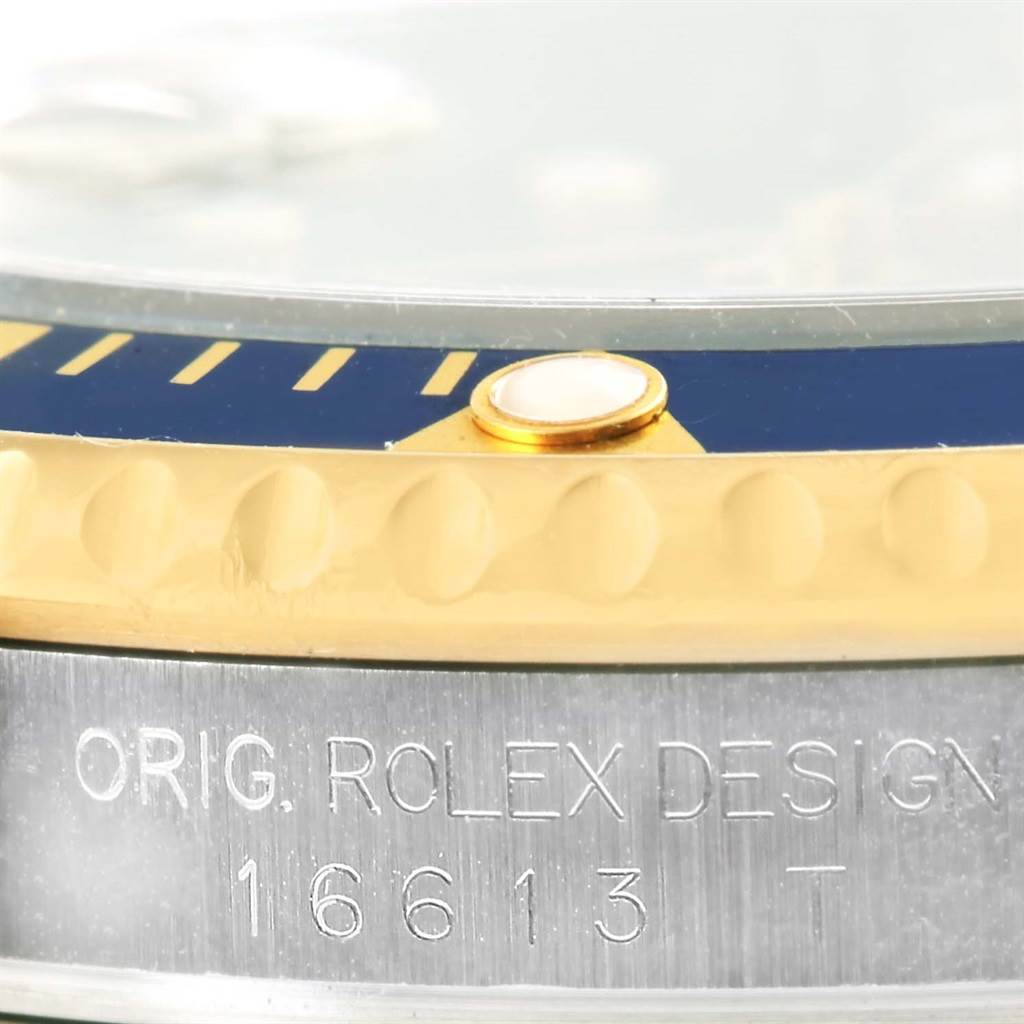 The image shows a close-up side view of the bezel and case, with model engravings of the Rolex Submariner 16613 Men
s Steel and Gold (two tone) Blue Dial 16613 Men
s Steel and Gold (two tone) Blue Dial.