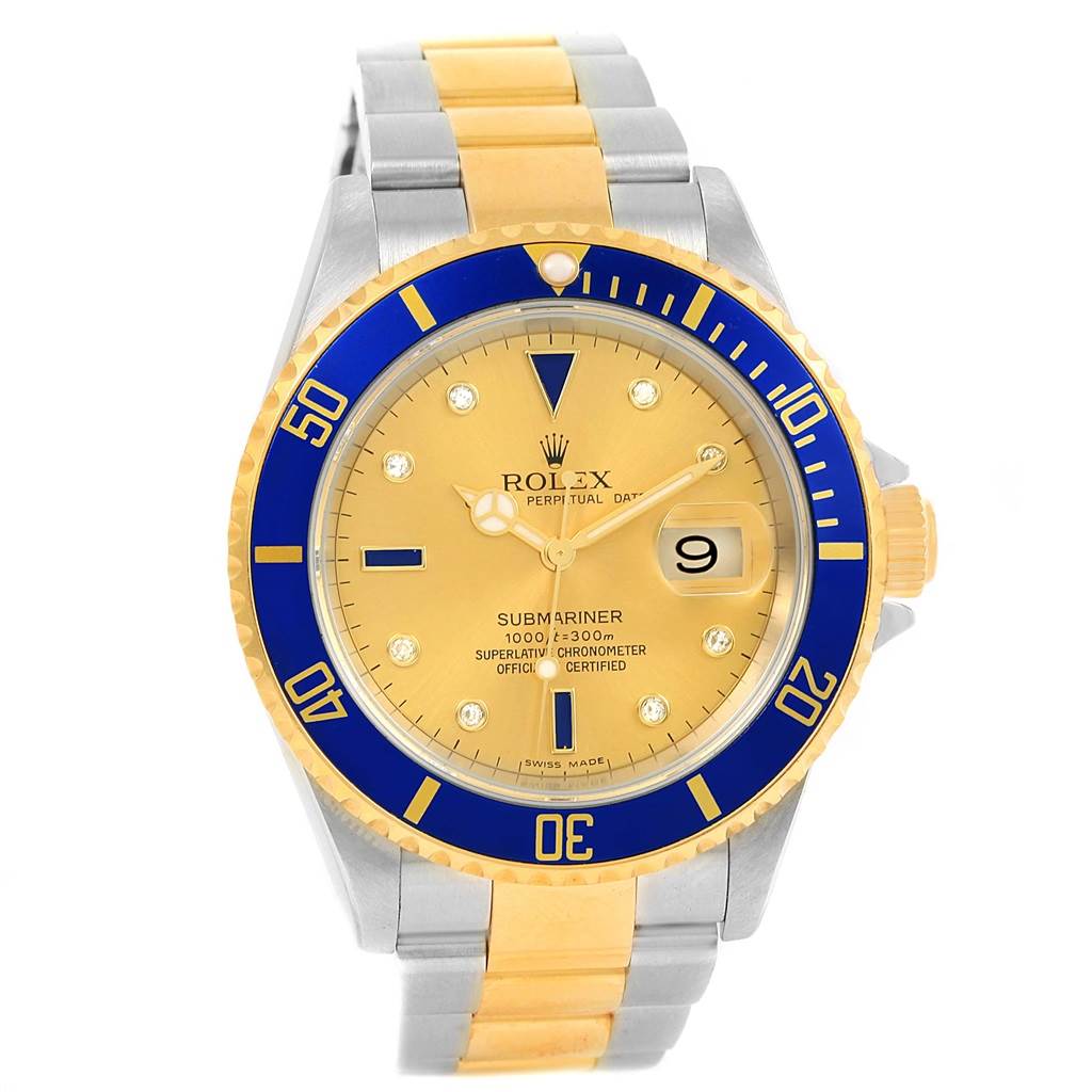 The image shows a front view of a Rolex Submariner 16613 Men
s Steel and Gold (two tone) Champagne Dial 16613 Men
s Steel and Gold (two tone) Champagne Dial watch with a gold and silver bracelet and a blue and gold bezel.