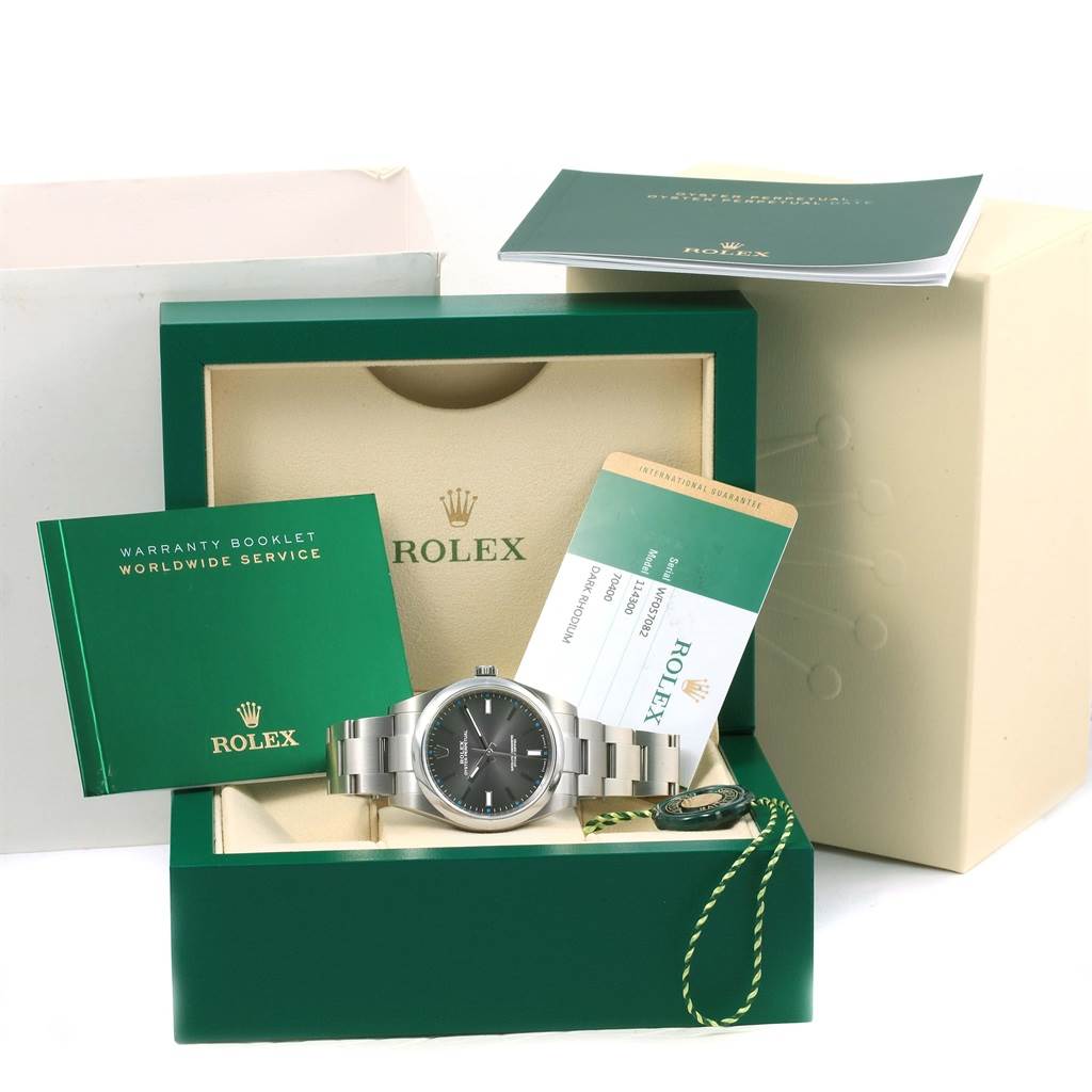 This image shows a Rolex Submariner 114300 Men's Stainless Steel Grey Dial 114300 Men's Stainless Steel Grey Dial watch with its box, warranty booklet, and certification card.