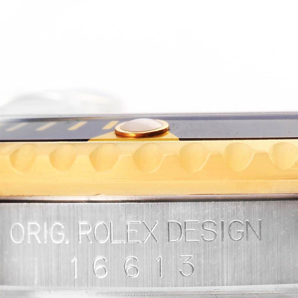 This image shows the side view of a Rolex Submariner 16613 Men
s Steel and Gold (two tone) Black Dial 16613 Men
s Steel and Gold (two tone) Black Dial, highlighting its bezel, edge, and engraved model number.