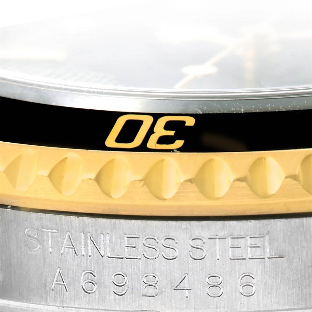 The image shows a close-up of the bezel and case edge of a Rolex Submariner 16613 Men
s Steel and Gold (two tone) Black Dial 16613 Men
s Steel and Gold (two tone) Black Dial watch.