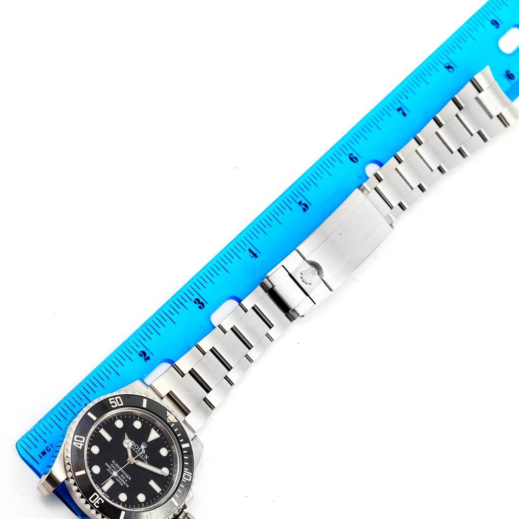 The image shows the watch face and metal bracelet of the Rolex Submariner 114060 Men's Stainless Steel Black Dial 114060 Men's Stainless Steel Black Dial model, aligned with a blue ruler for measurement.