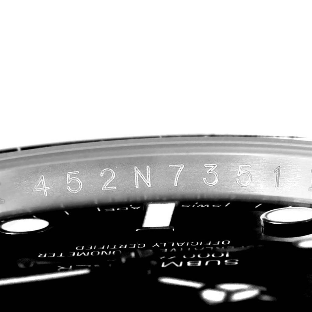 The image shows a close-up of the rehaut with engraved serial number inside a Rolex Submariner 114060 Men's Stainless Steel Black Dial 114060 Men's Stainless Steel Black Dial watch.