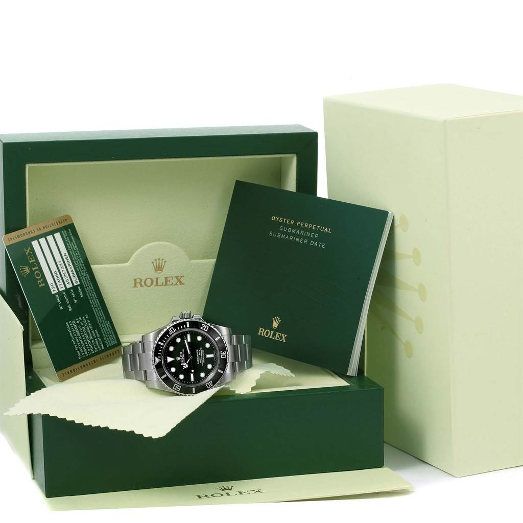 The image shows a Rolex Submariner 114060 Men's Stainless Steel Black Dial 114060 Men's Stainless Steel Black Dial watch with its box, warranty card, and instruction booklets, displayed at an angle.