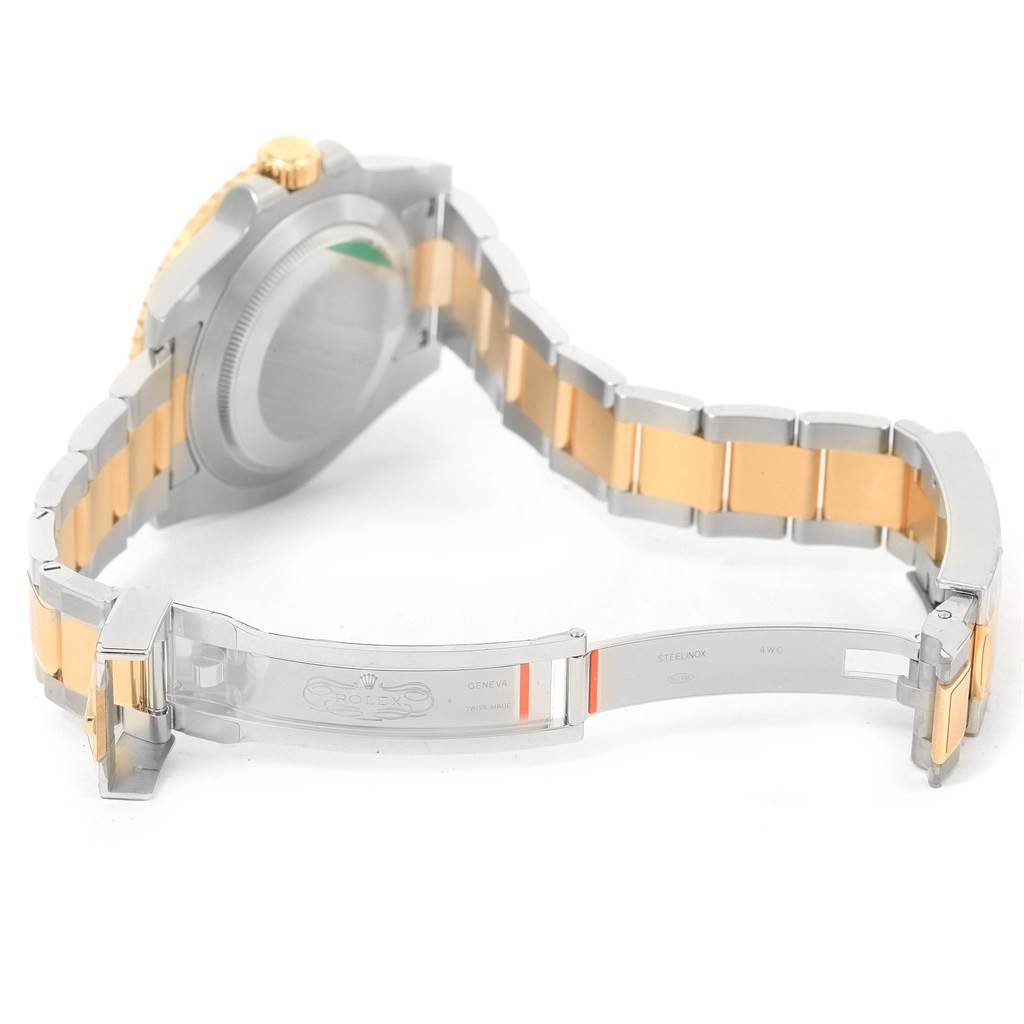 The image shows the back view of a Rolex Submariner 116613 Men
s Steel and Gold (two tone) Black Dial 116613 Men
s Steel and Gold (two tone) Black Dial with its bracelet and clasp fully opened, highlighting the bi-metallic links and clasp mechanism.