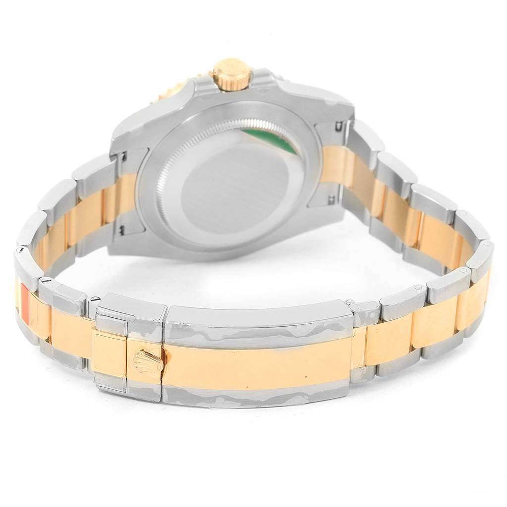 The image shows the backside of a Rolex Submariner 116613 Men
s Steel and Gold (two tone) Black Dial 116613 Men
s Steel and Gold (two tone) Black Dial watch, focusing on the bracelet and clasp.