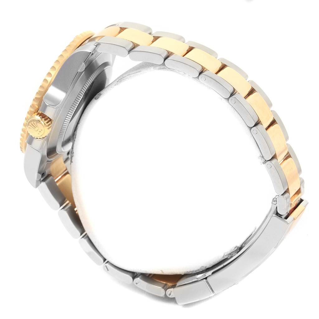 The image shows a side view of the Rolex Submariner 116613 Men
s Steel and Gold (two tone) Black Dial 116613 Men
s Steel and Gold (two tone) Black Dial
s two-tone bracelet, crown, and part of the case.