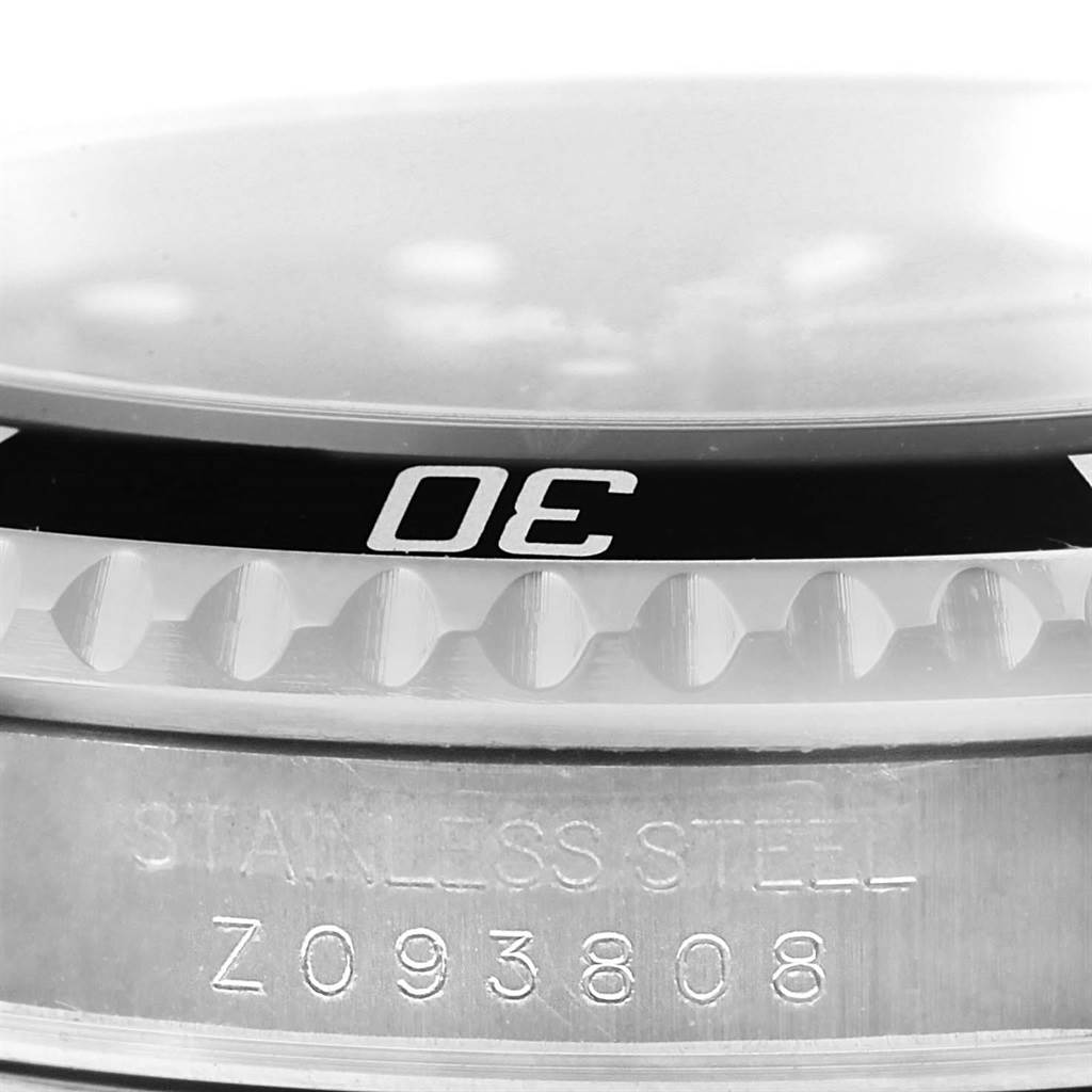 This image shows a close-up angle of the bezel and some engraved text on the case of the Rolex Submariner 16610 Men's Stainless Steel Black Dial 16610 Men's Stainless Steel Black Dial watch.