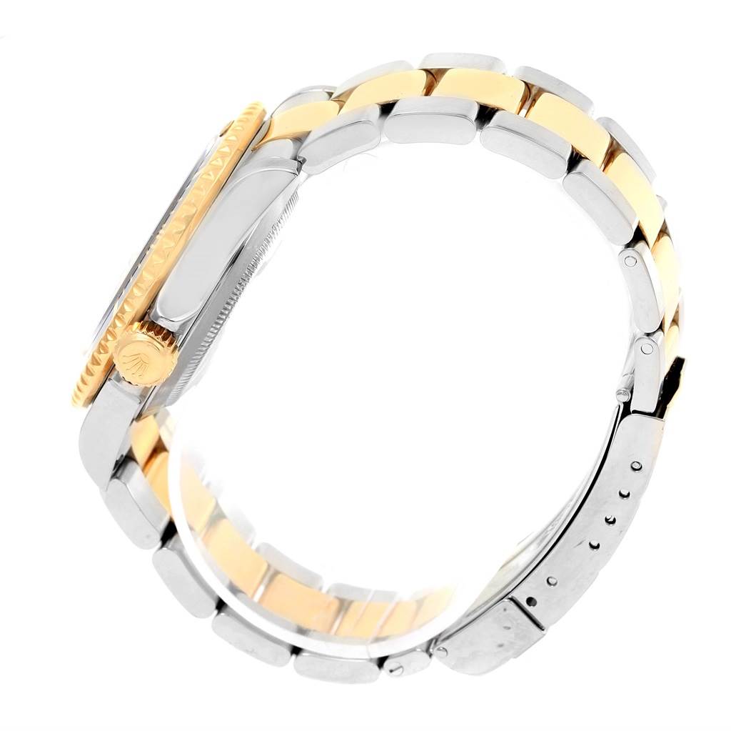 The image shows a side view of a Rolex Submariner 16613 Men's Steel and Gold (two tone) Blue Dial 16613 Men's Steel and Gold (two tone) Blue Dial watch, highlighting its crown, case, and two-tone bracelet.