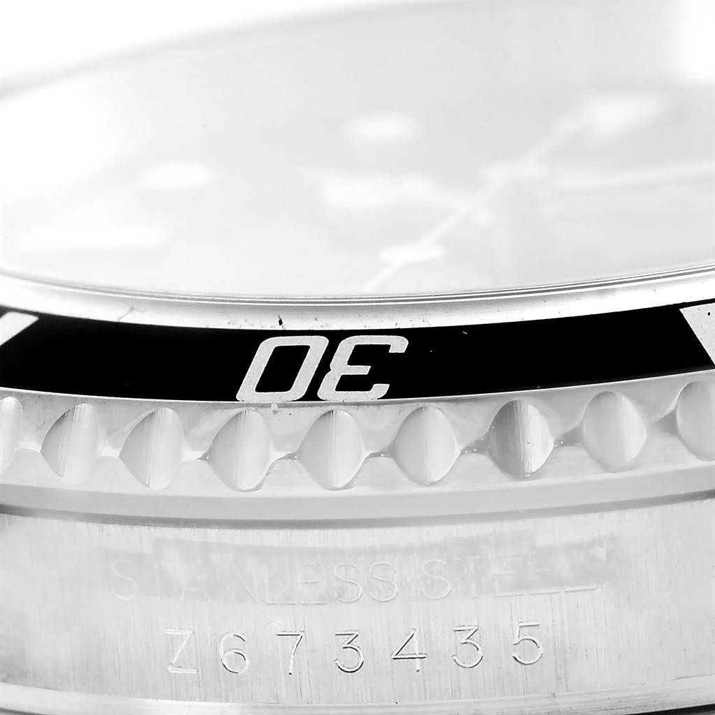 The image shows a close-up of the bezel, case edge, and serial number of a Rolex Submariner 16610 Men's Stainless Steel Black Dial 16610 Men's Stainless Steel Black Dial watch.