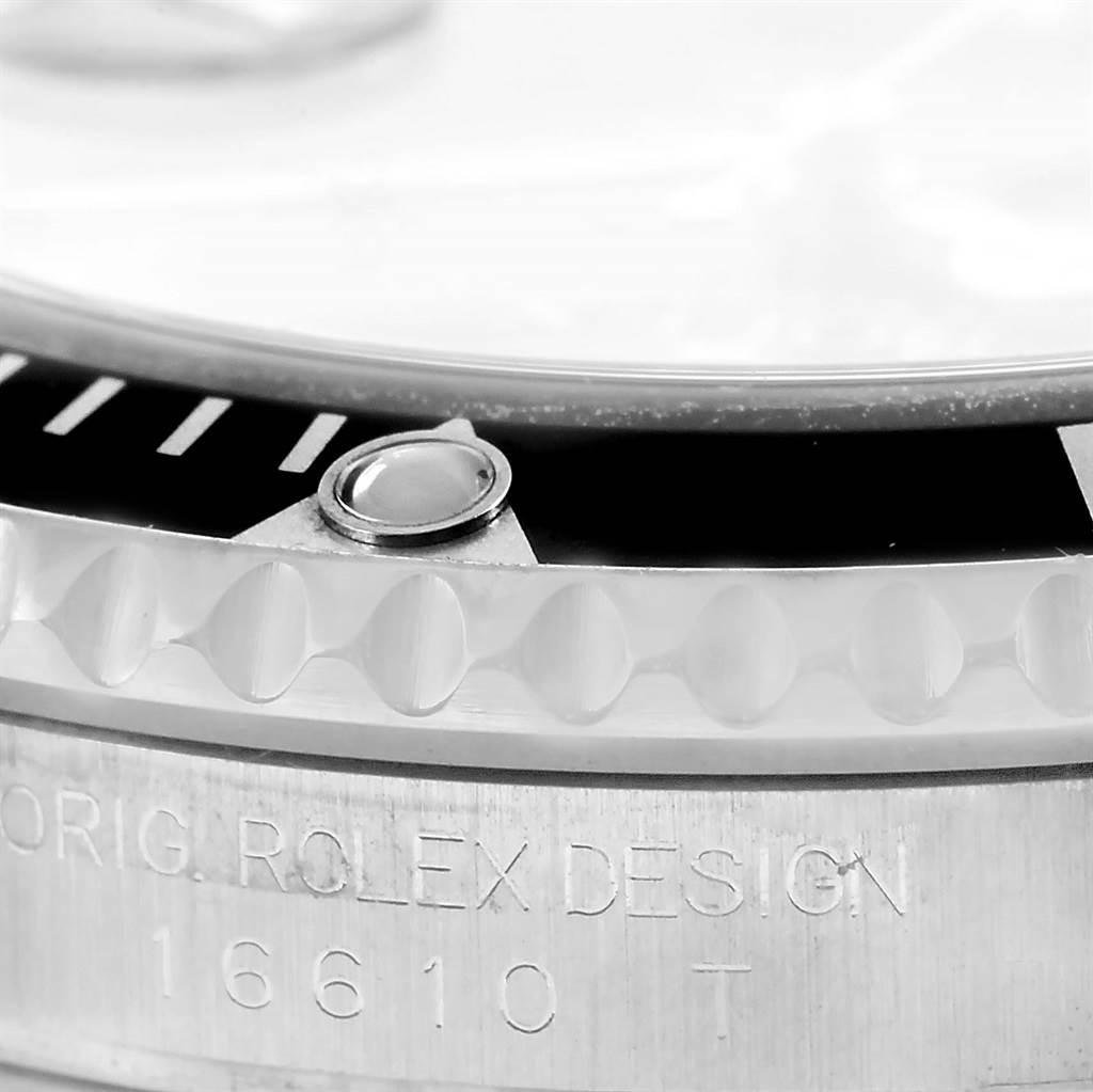 The image shows a close-up of the bezel, crystal, and crown of the Rolex Submariner 16610 Men's Stainless Steel Black Dial 16610 Men's Stainless Steel Black Dial with the model number engraved.
