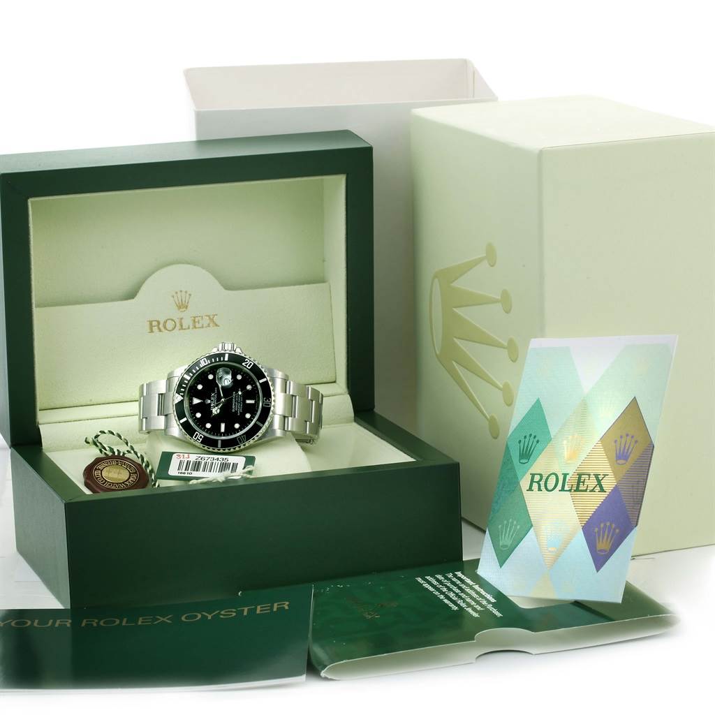 The image shows a Rolex Submariner 16610 Men's Stainless Steel Black Dial 16610 Men's Stainless Steel Black Dial watch in its open box with accessories, tag, and booklets, viewed from the front at an eye level.