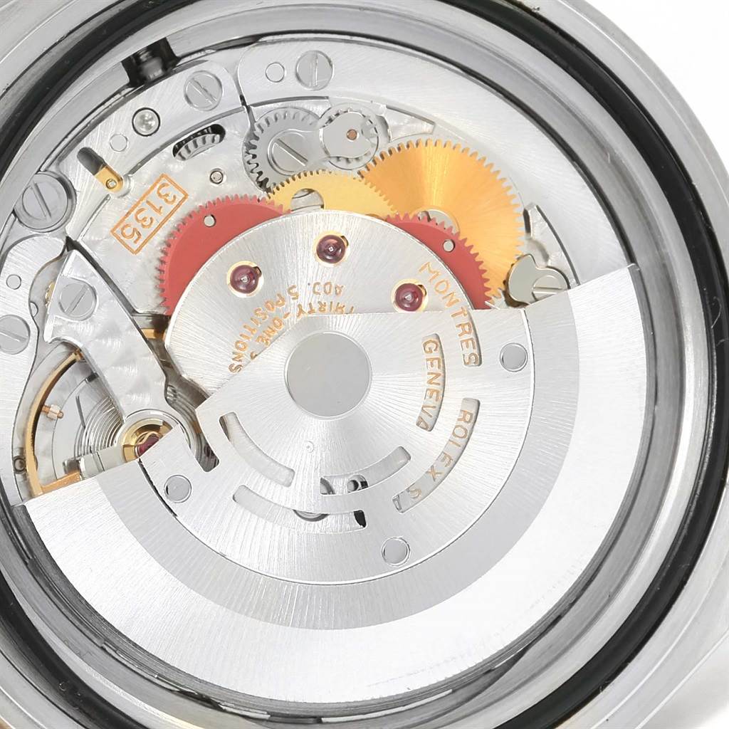 The image shows a close-up view of the movement inside a Rolex Submariner 16613 Men's Steel and Gold (two tone) Blue Dial 16613 Men's Steel and Gold (two tone) Blue Dial watch, revealing gears and mechanical components.