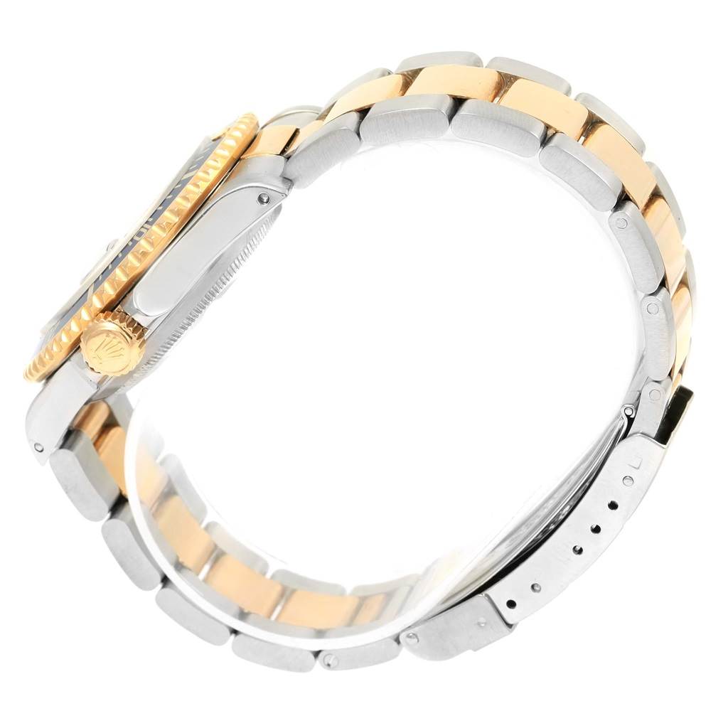 This image shows a side view of a Rolex Submariner 16613 Men's Steel and Gold (two tone) Blue Dial 16613 Men's Steel and Gold (two tone) Blue Dial watch, focusing on the crown, bezel, and bracelet.