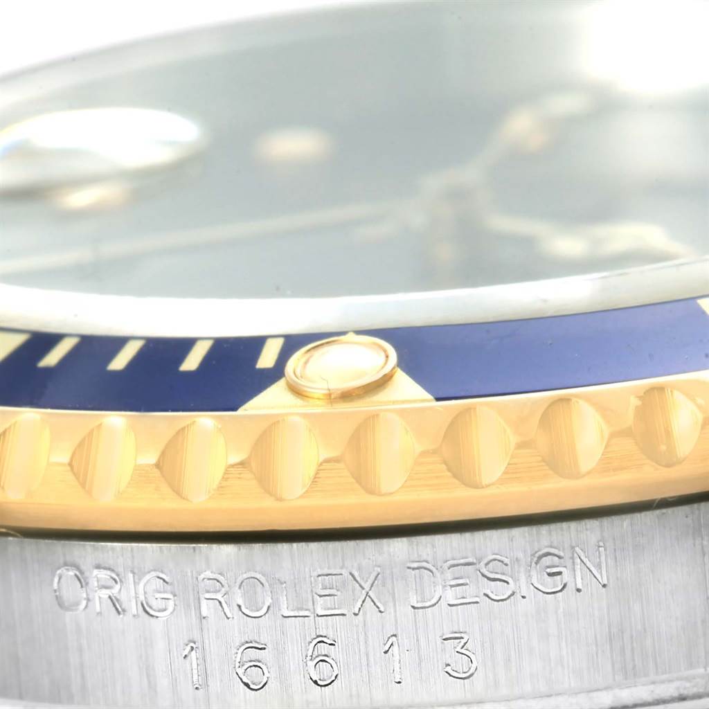 This close-up angle shows the bezel, case side, and engravings of the Rolex Submariner 16613 Men's Steel and Gold (two tone) Blue Dial 16613 Men's Steel and Gold (two tone) Blue Dial model.