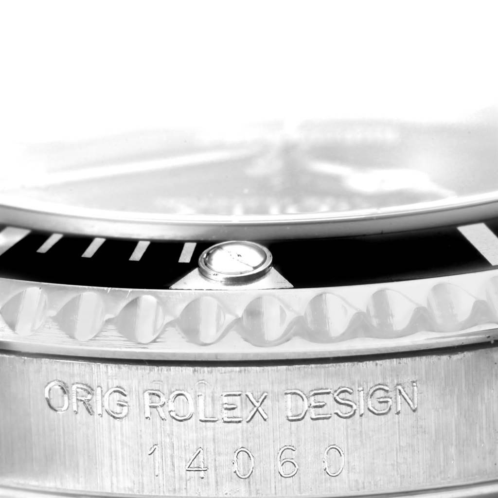 This image shows a close-up of the case edge and bezel of a Rolex Submariner 14060 Men's Stainless Steel Black Dial 14060 Men's Stainless Steel Black Dial, including the model number and design engraving.
