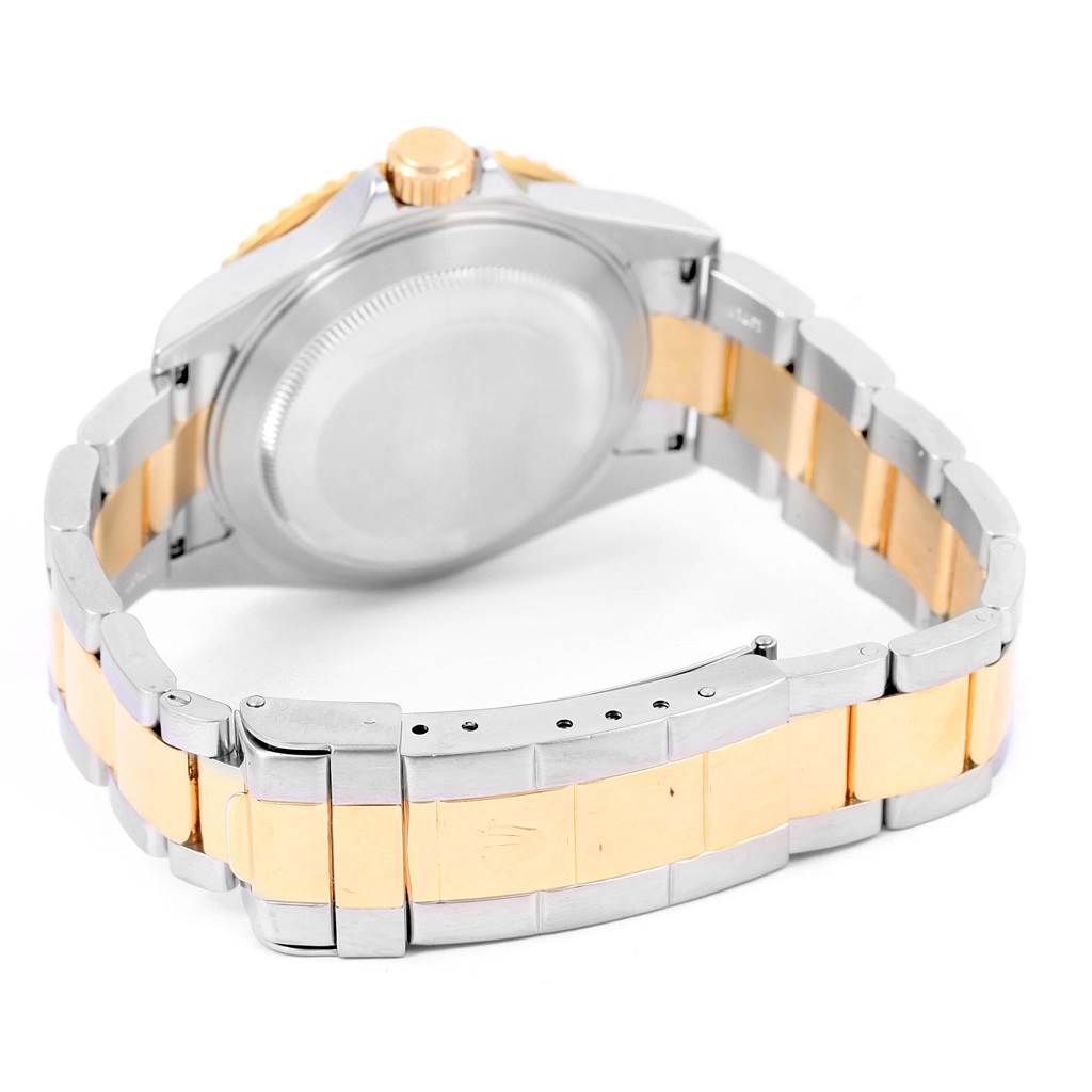 This Rolex Submariner 16613 Men's Steel and Gold (two tone) Blue Dial 16613 Men's Steel and Gold (two tone) Blue Dial model is shown from the backside, highlighting the case back, crown, and two-tone bracelet.