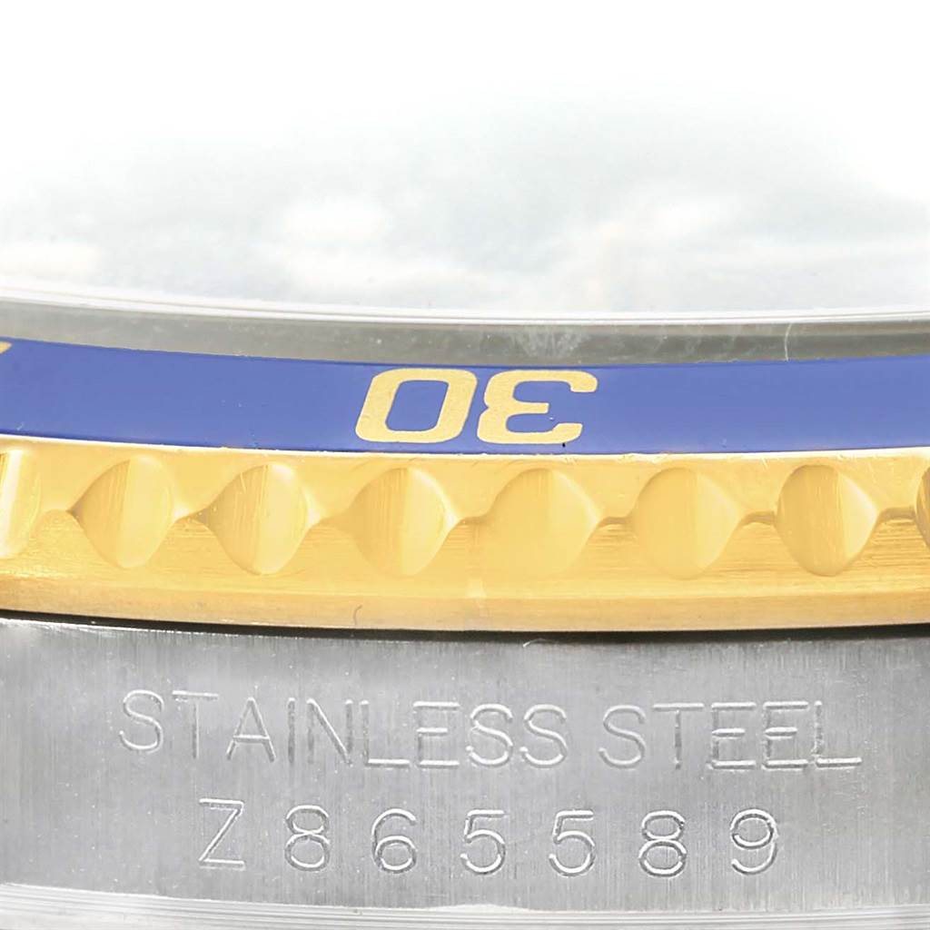 This close-up image shows the bezel and part of the case with the serial number of a Rolex Submariner 16613 Men's Steel and Gold (two tone) Blue Dial 16613 Men's Steel and Gold (two tone) Blue Dial watch.
