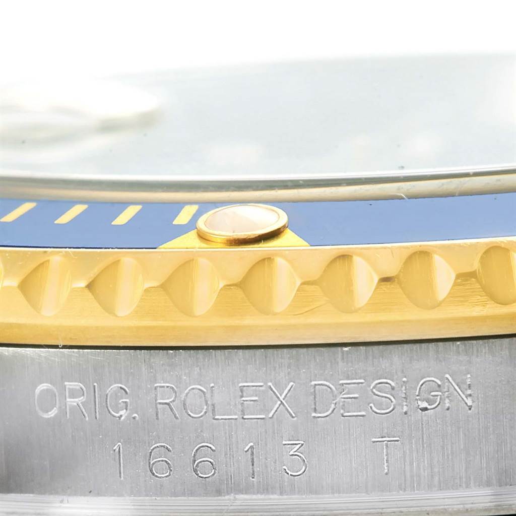 This image shows a close-up of the bezel and case of a Rolex Submariner 16613 Men's Steel and Gold (two tone) Blue Dial 16613 Men's Steel and Gold (two tone) Blue Dial model, showing the model number 16613.