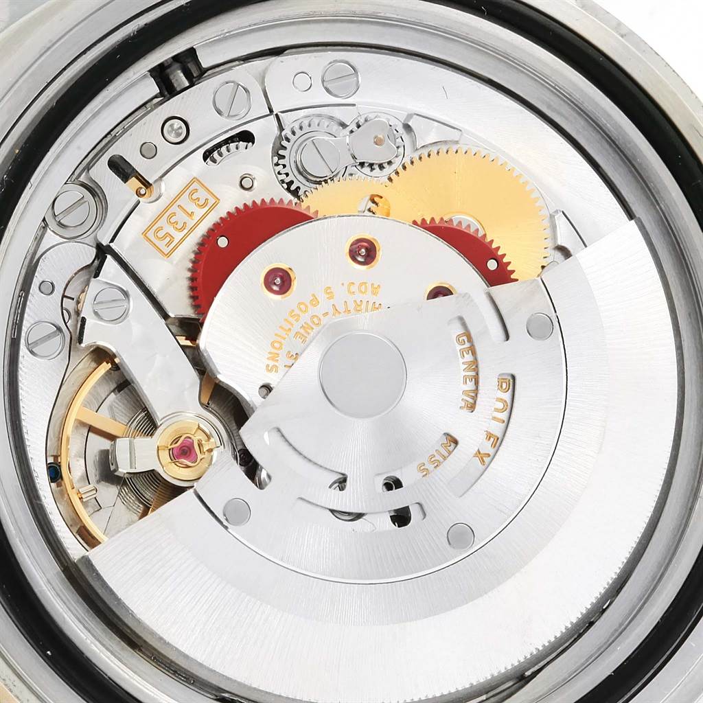 This image shows the internal mechanism and movement of a Rolex Submariner 16613 Men's Steel and Gold (two tone) Blue Dial 16613 Men's Steel and Gold (two tone) Blue Dial watch viewed from the back.