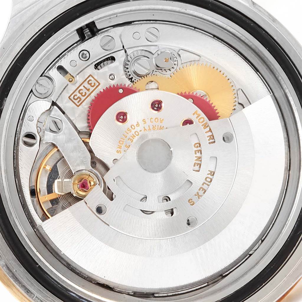 The image shows a close-up view of the movement mechanism of a Rolex Submariner 16613 Men's Steel and Gold (two tone) Blue Dial 16613 Men's Steel and Gold (two tone) Blue Dial watch.