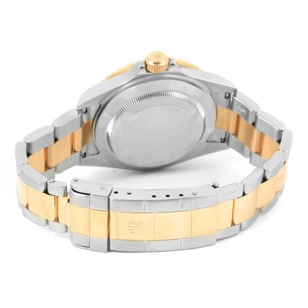 The image shows the back view of a Rolex Submariner 16613 Men's Steel and Gold (two tone) Blue Dial 16613 Men's Steel and Gold (two tone) Blue Dial watch, focusing on the clasp, bracelet, and case back.