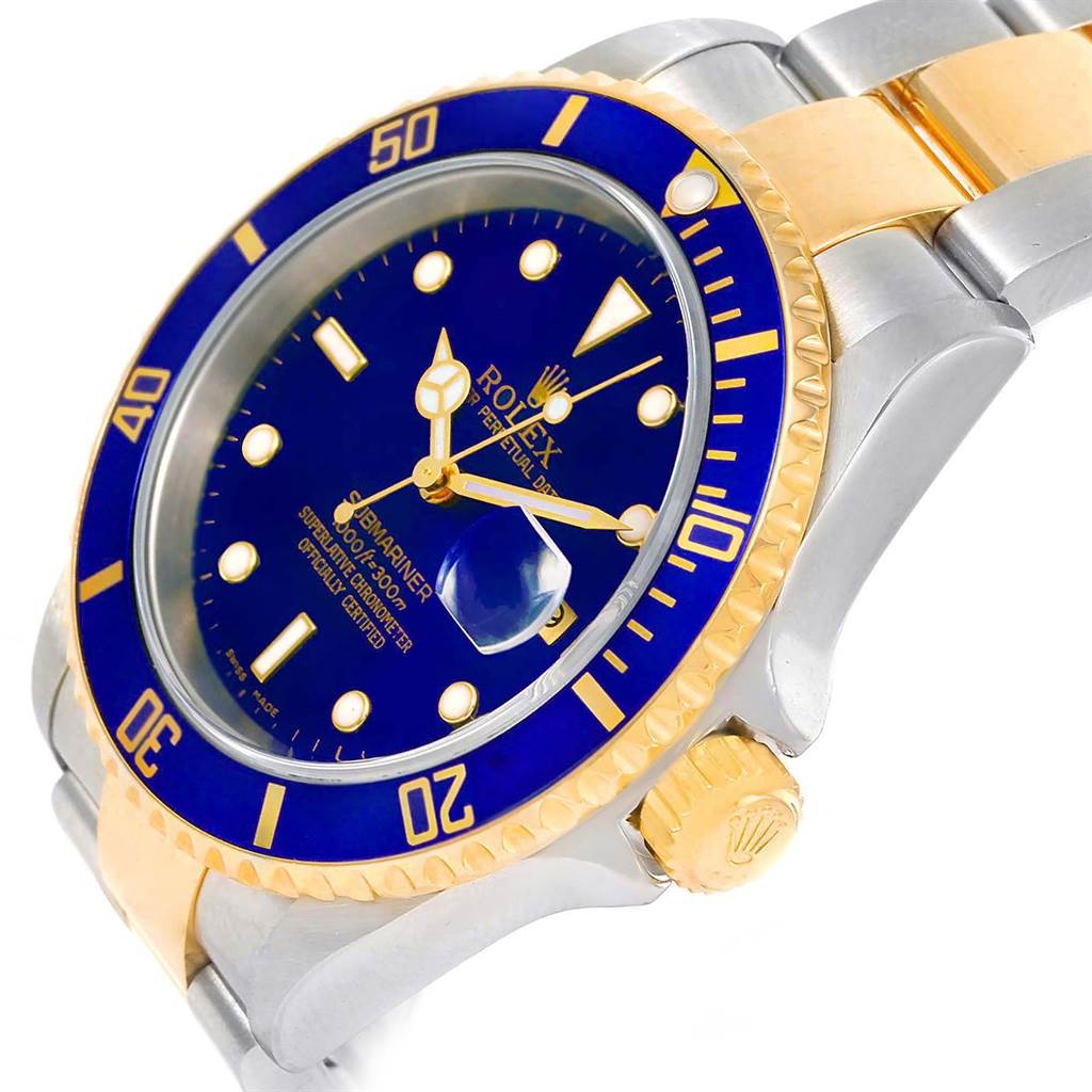 This image shows an angled close-up of a Rolex Submariner 16613 Men's Steel and Gold (two tone) Blue Dial 16613 Men's Steel and Gold (two tone) Blue Dial watch featuring a blue dial, gold bezel, and a two-tone bracelet.