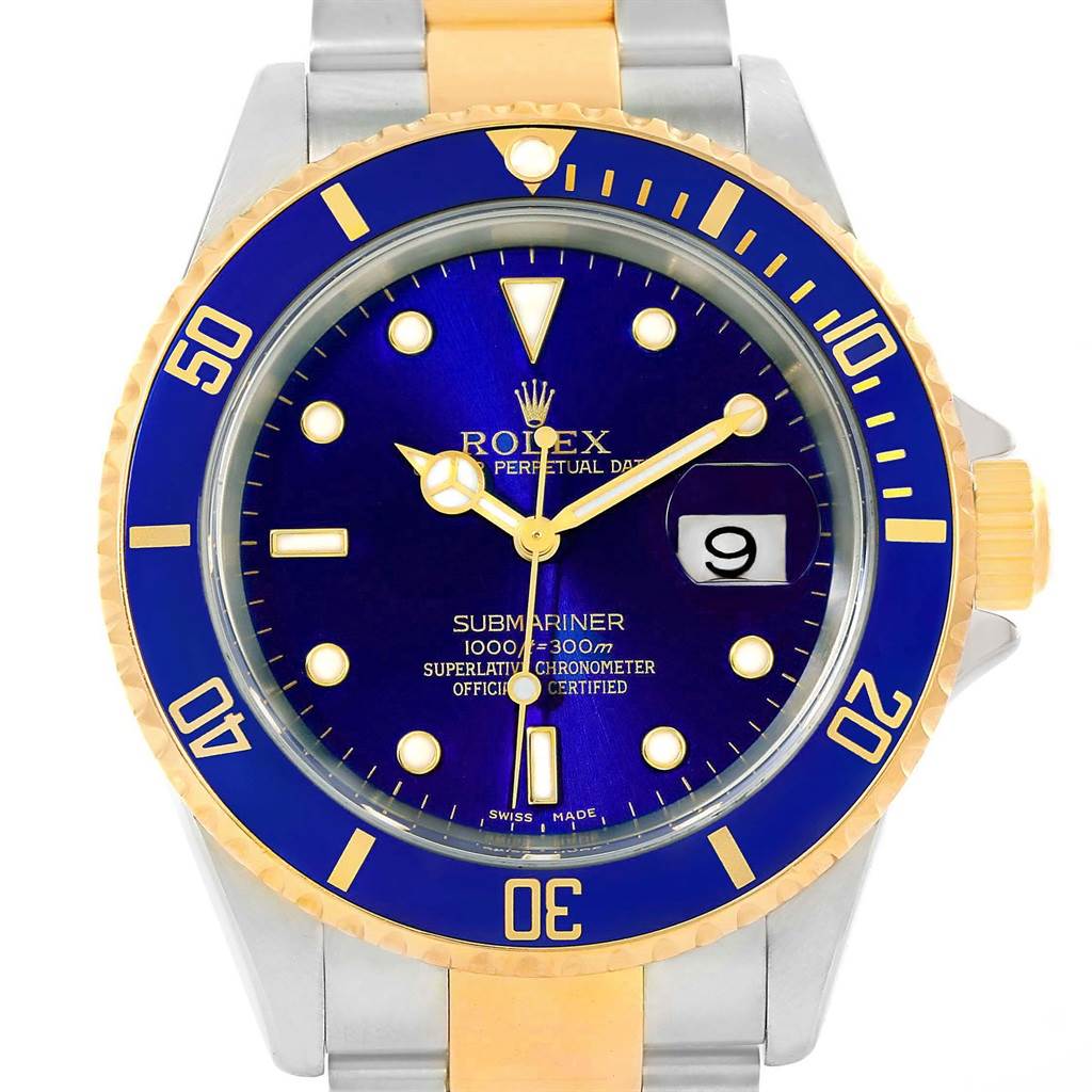 The angled close-up of the Rolex Submariner 16613 Men's Steel and Gold (two tone) Blue Dial 16613 Men's Steel and Gold (two tone) Blue Dial watch shows its face, bezel, crown, and part of the bracelet.